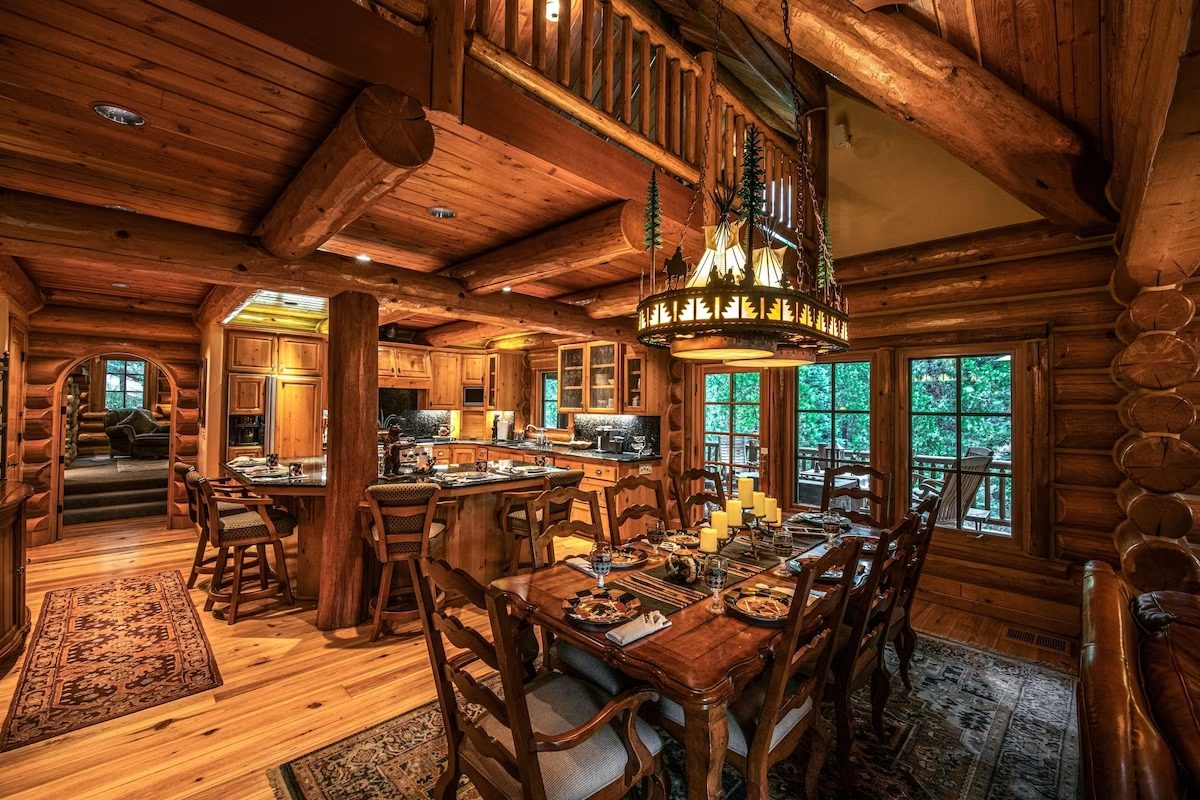 A large dining room with wooden floors and walls.