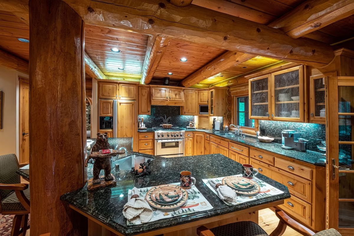 A kitchen with wooden cabinets and granite counter tops.