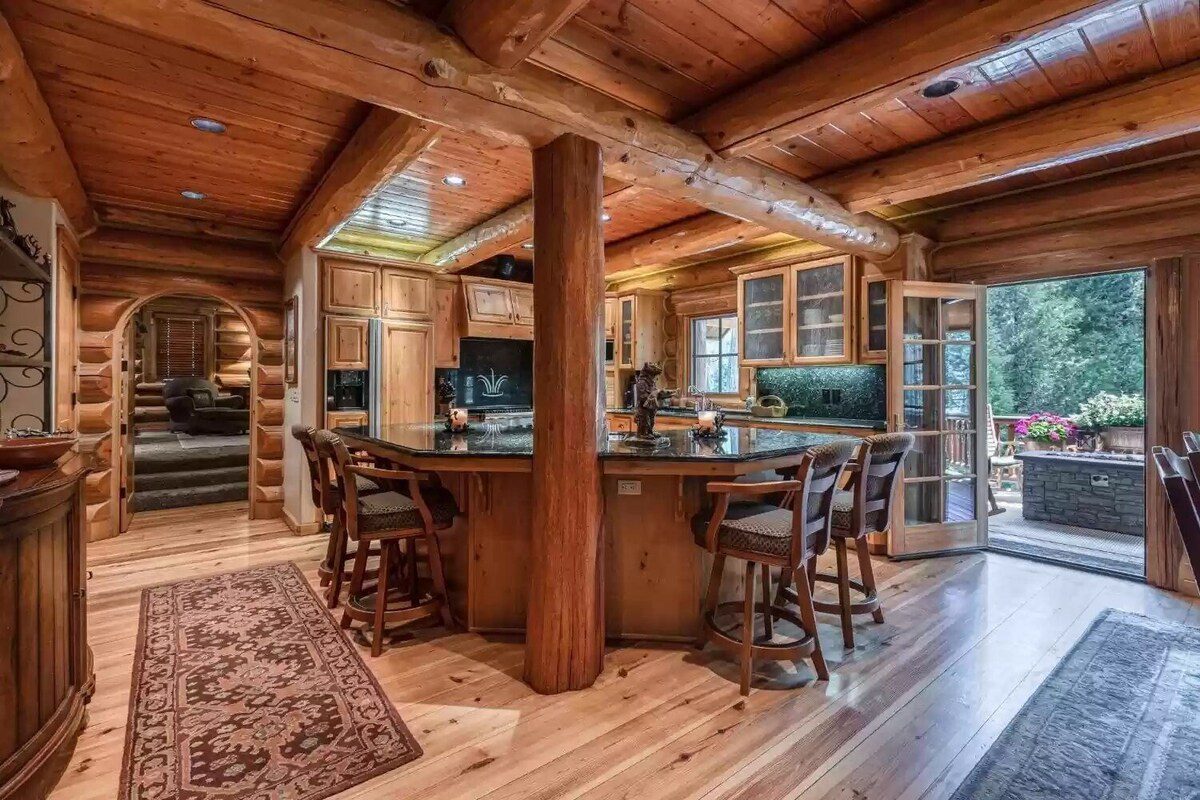 A kitchen with wooden floors and a bar