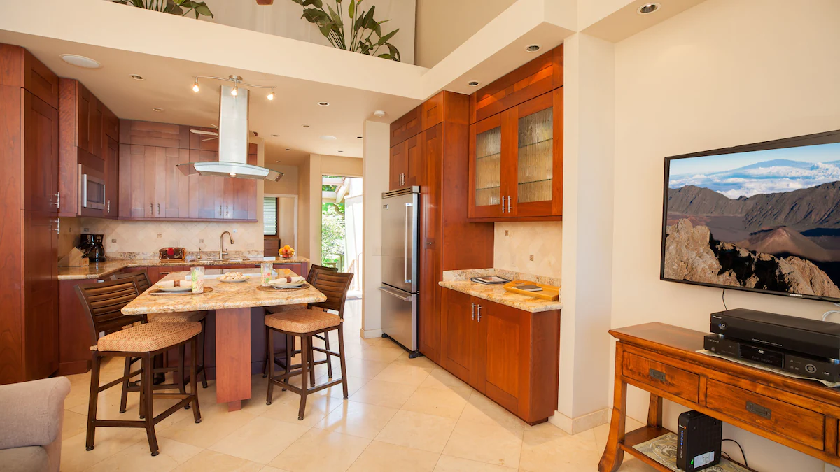 A kitchen with wooden cabinets and white tile floors.