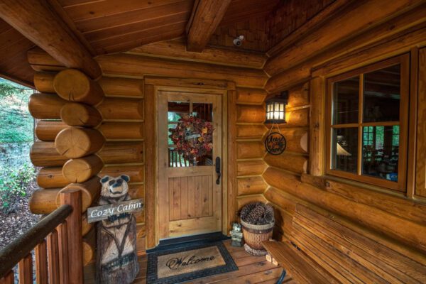 A wooden cabin with a door and window.