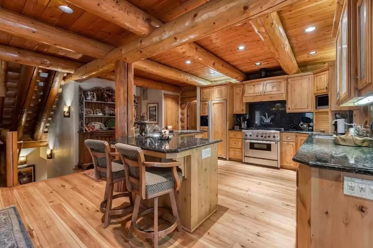 A kitchen with wooden floors and cabinets