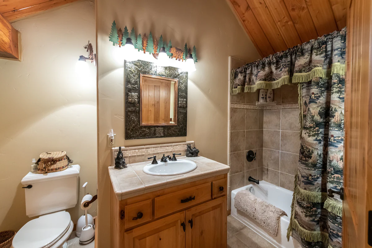 A bathroom with a sink, toilet and bathtub.