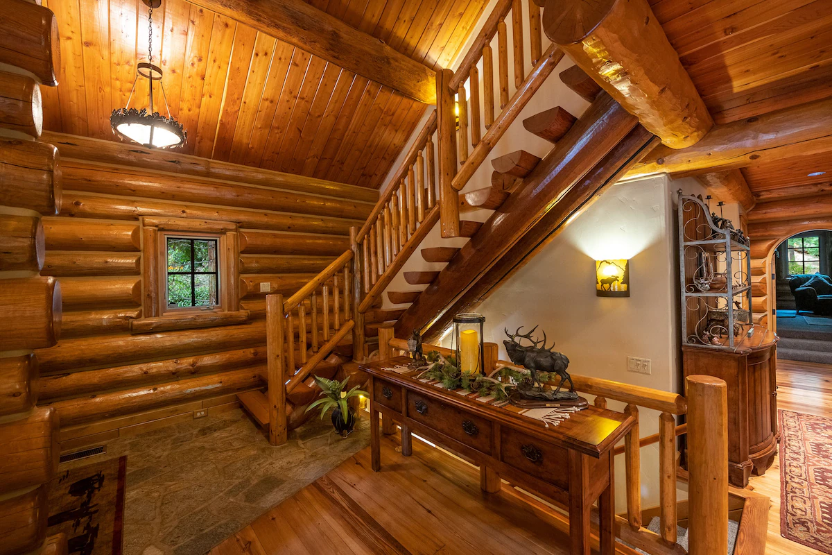 A wooden staircase in the middle of a room.