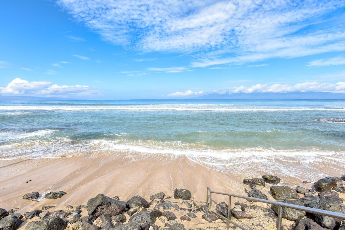 A beach with rocks and water on it