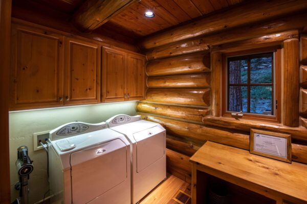 A room with wood paneling and a washer and dryer.