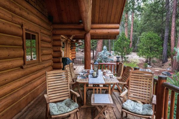 A wooden deck with chairs and tables on it