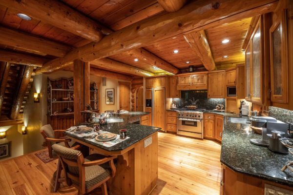 A kitchen with wooden floors and walls.