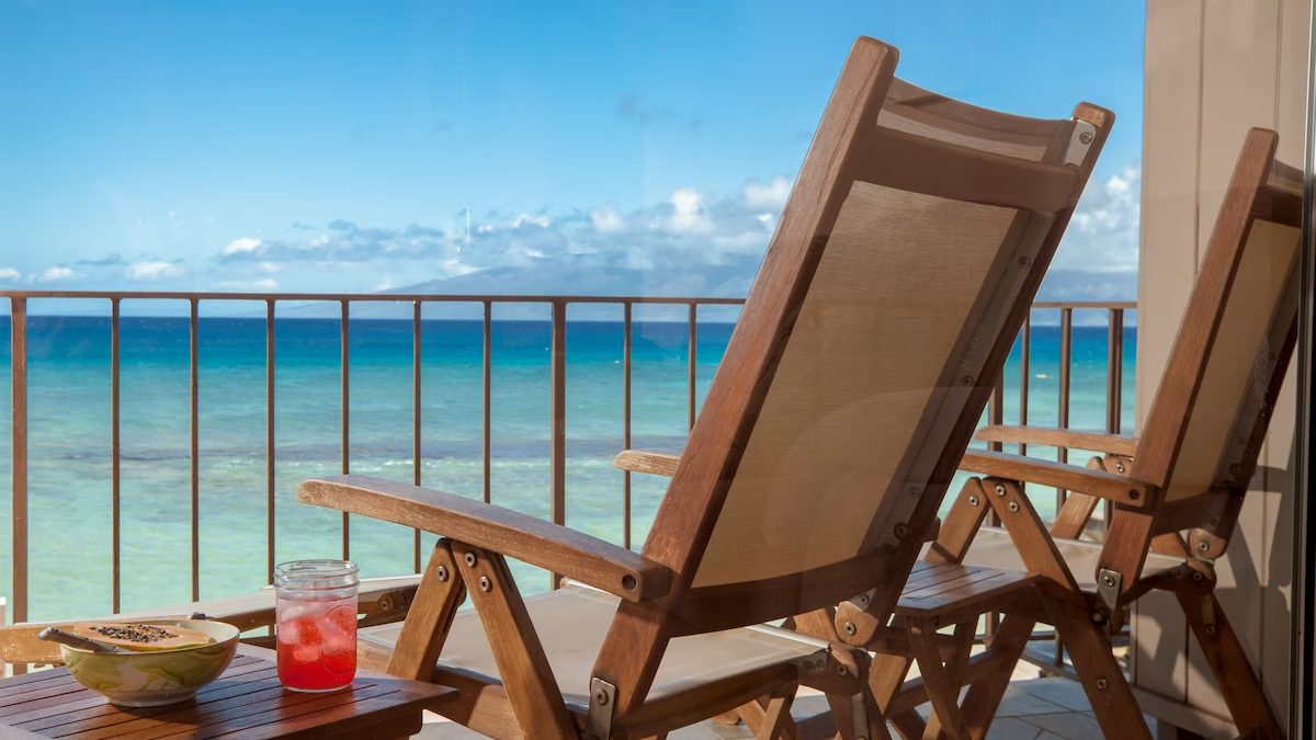 A wooden chair on the beach with drinks