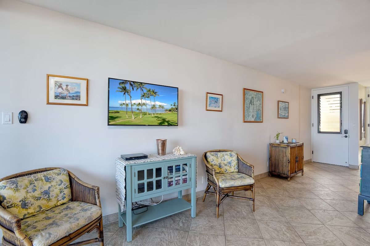 A living room with a tv and some chairs