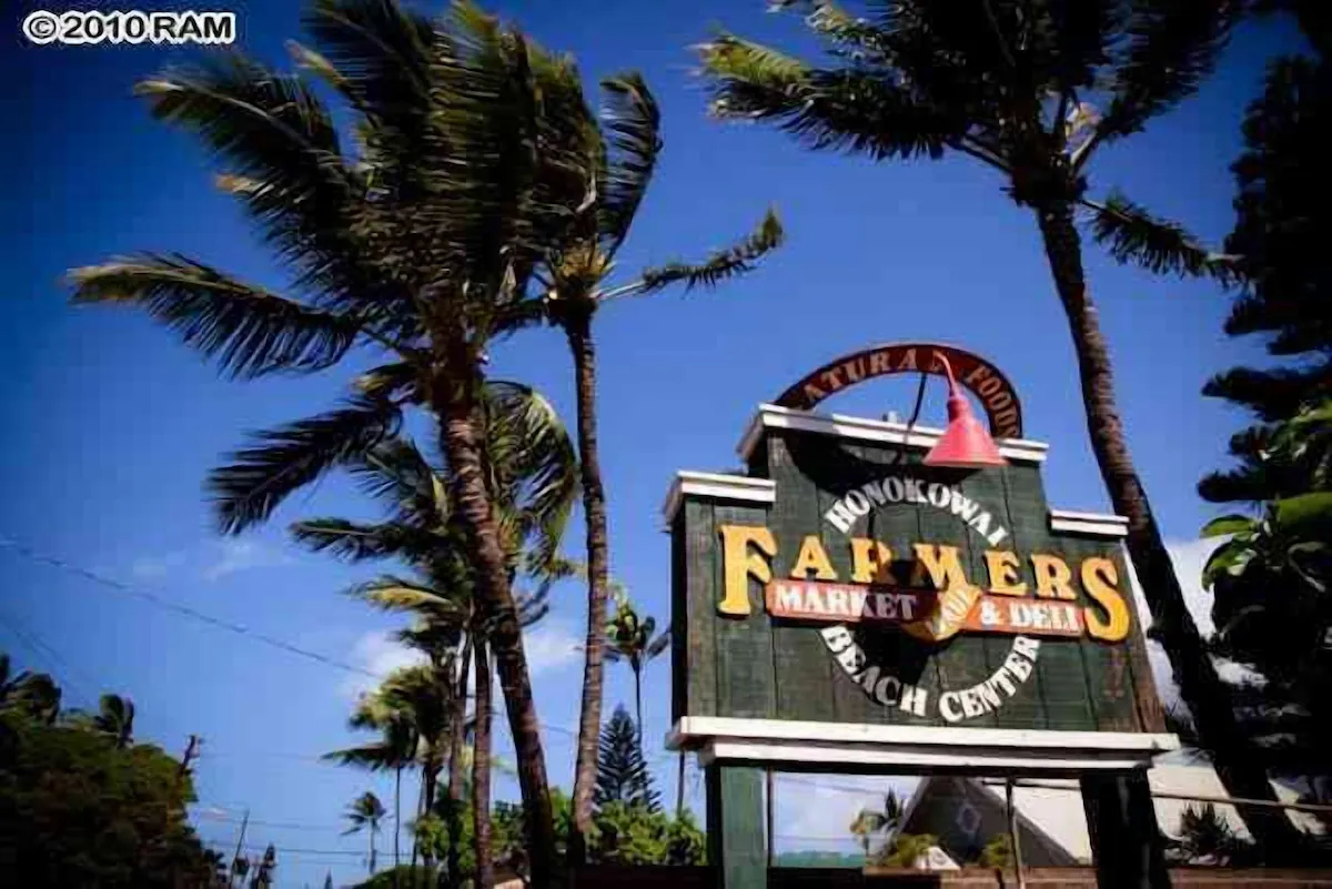 A sign for farmers market and beach center.