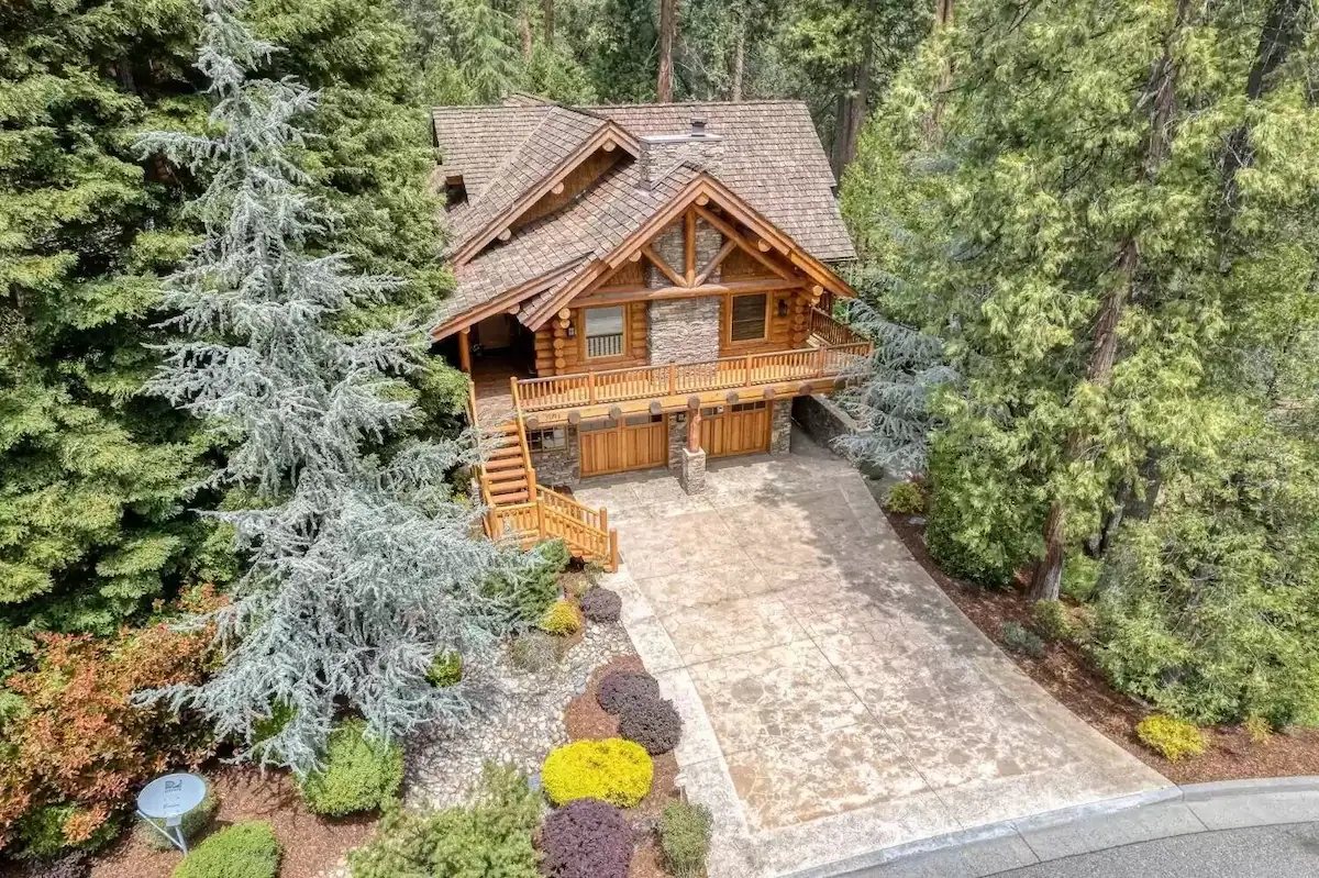 A house with a lot of trees in the background