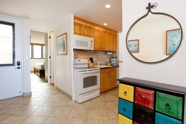 A kitchen with a stove, microwave and refrigerator.