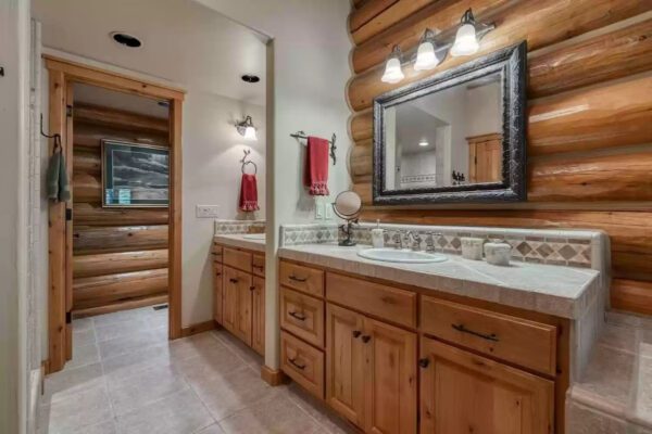 A bathroom with two sinks and a mirror.