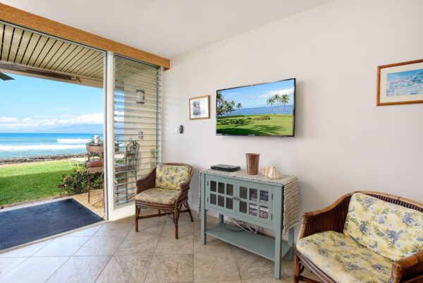 A living room with chairs and a television.