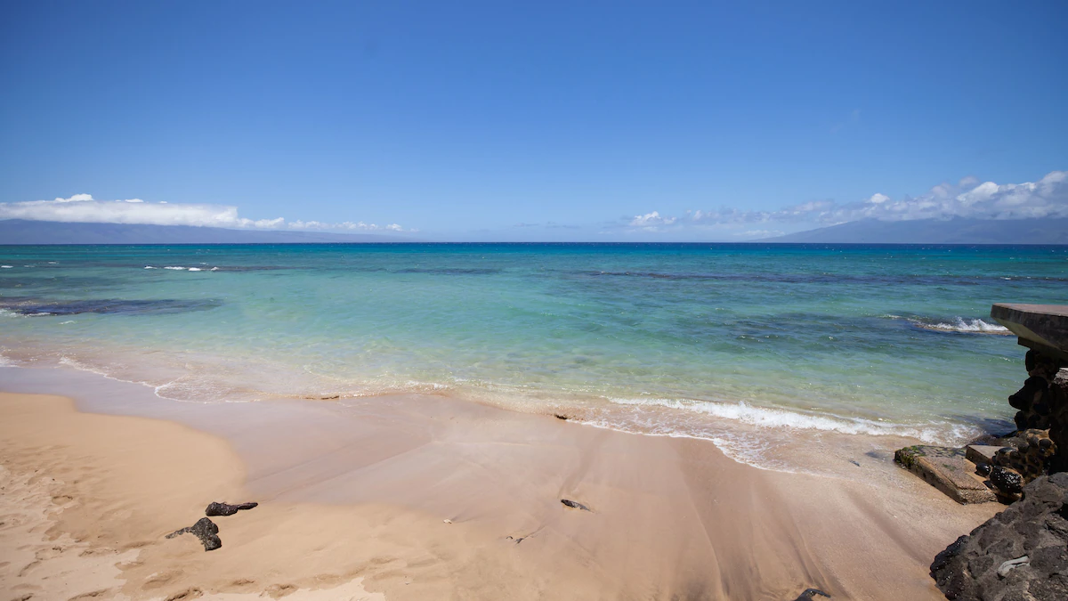 A beach with some water and sand on it