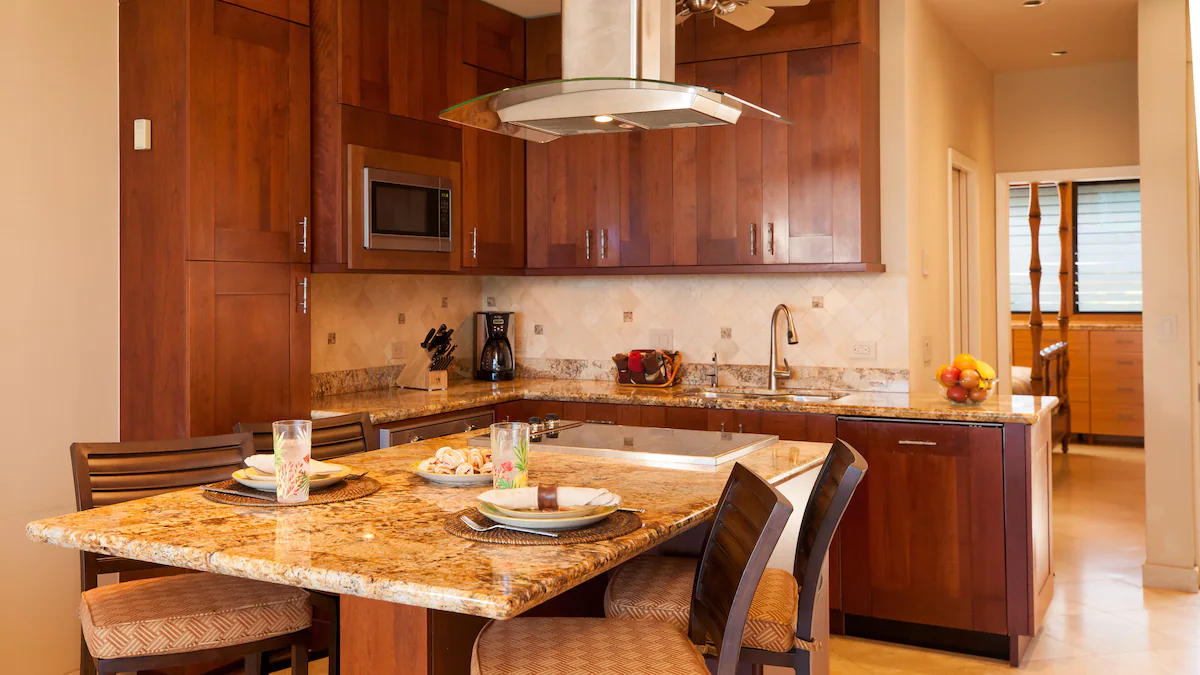 A kitchen with wooden cabinets and a marble counter.