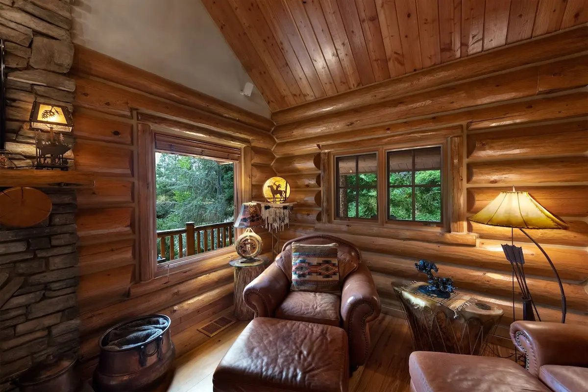 A living room with wood paneled walls and ceiling.