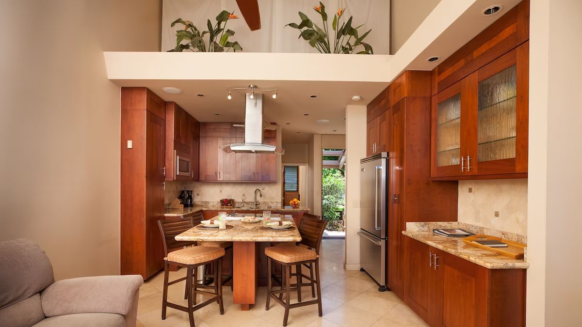 A kitchen with wooden cabinets and island in it