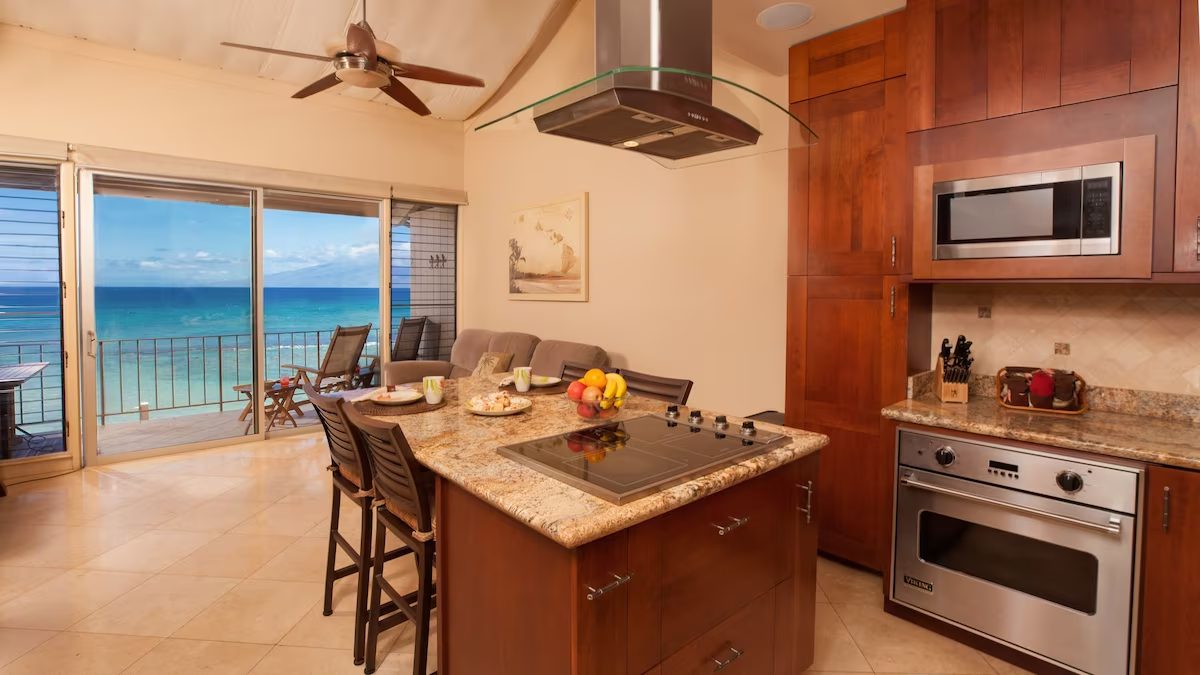 A kitchen with an island and a stove.