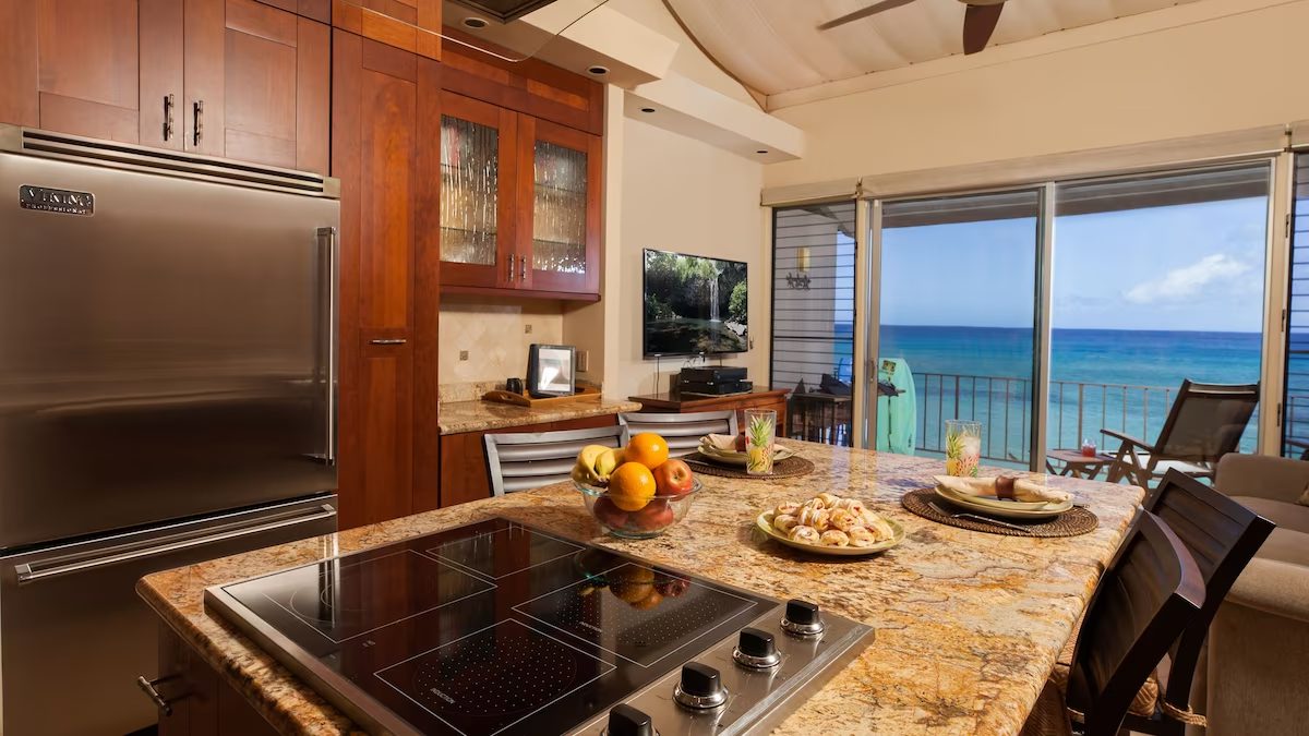 A kitchen with an ocean view and a stove.