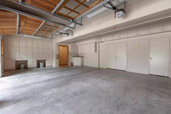 A garage with concrete floors and white walls.