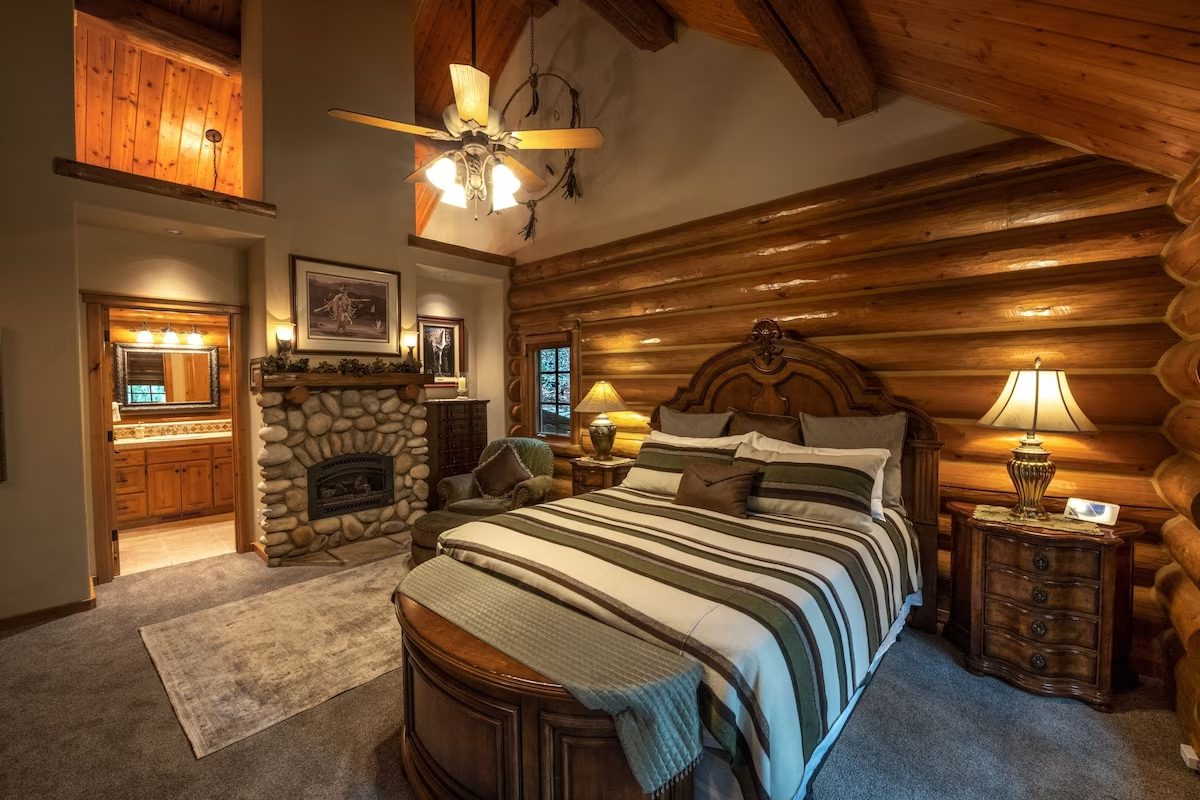 A bedroom with a fireplace and a bed in it