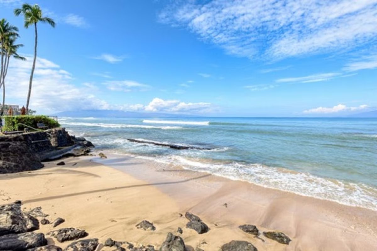 A beach with rocks and water on it