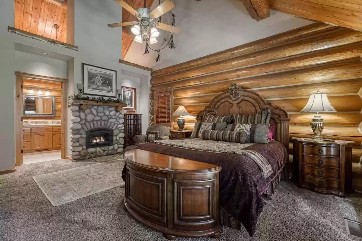 A bedroom with a fireplace and a bed in it