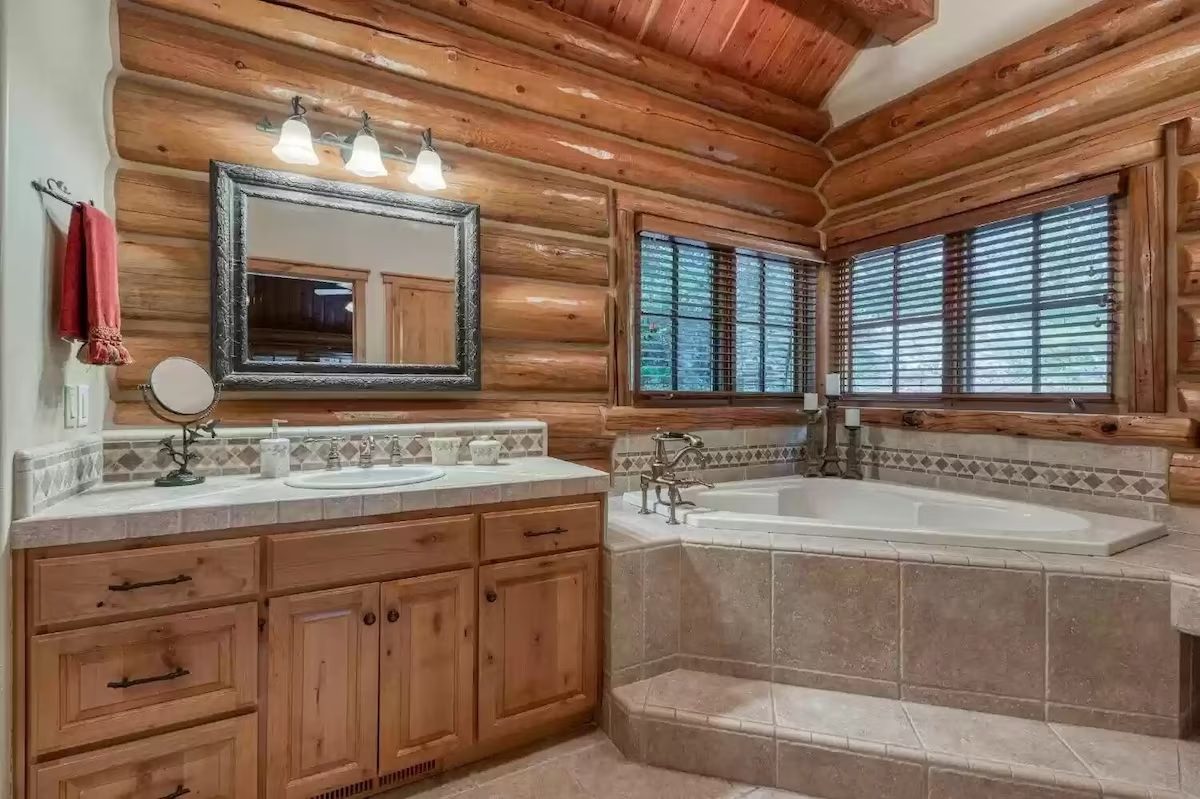 A bathroom with a large tub and sink.