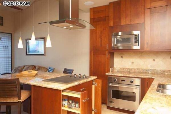 A kitchen with wooden cabinets and stainless steel appliances.