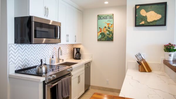 A kitchen with white cabinets and stainless steel appliances.