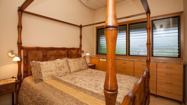 A bed room with a wooden four poster bed