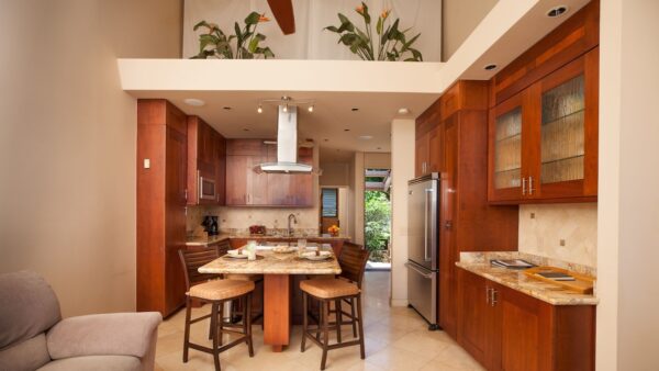 A kitchen with wooden cabinets and a table