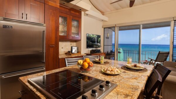 A kitchen with an ocean view and a stove.