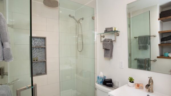 A bathroom with a shower and sink in it