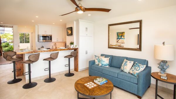 A living room with a blue couch and a table